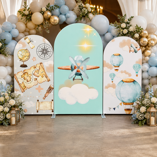 Travel arch backdrop decorated with flowers and balloons