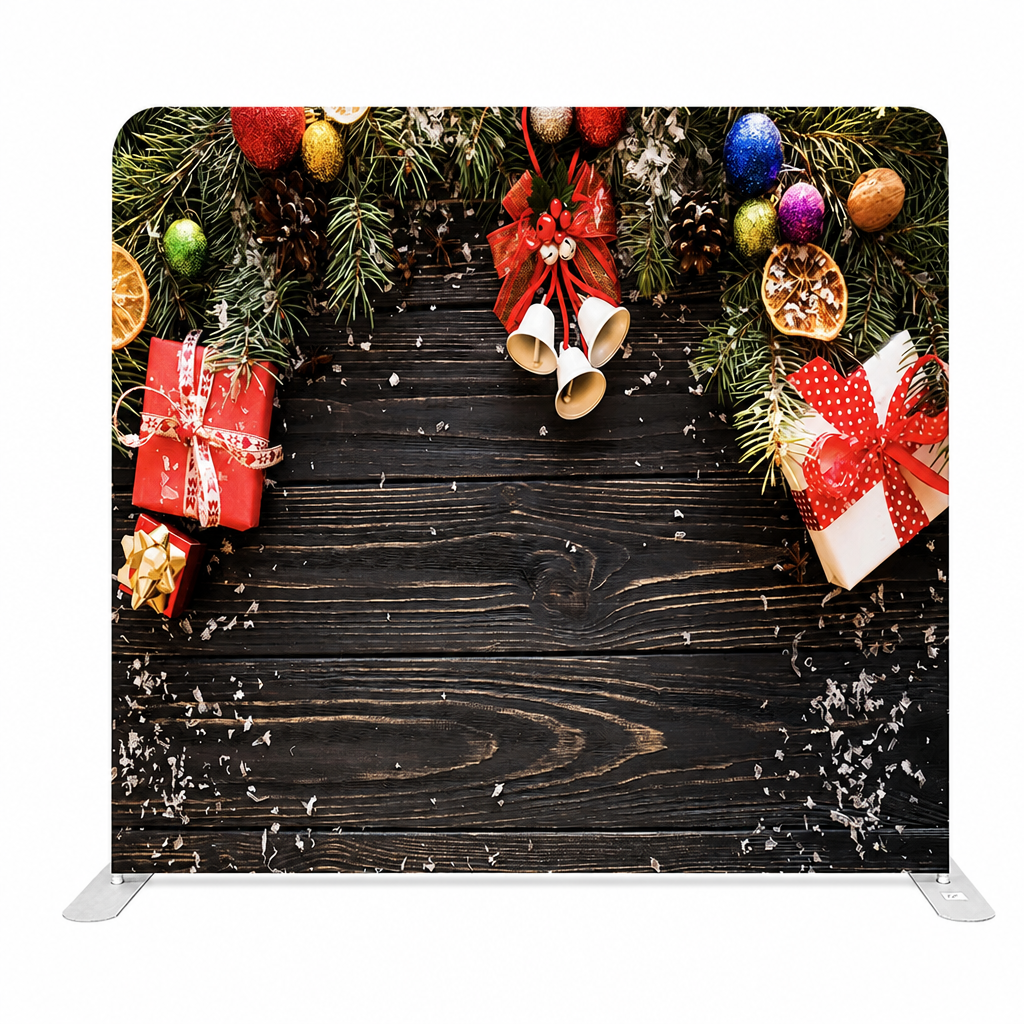 Christmas backdrop with festive gifts and bells on wooden background