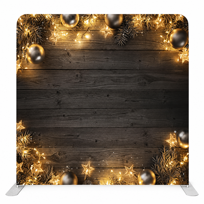 Black wooden festive backdrop with gold lights and ornaments