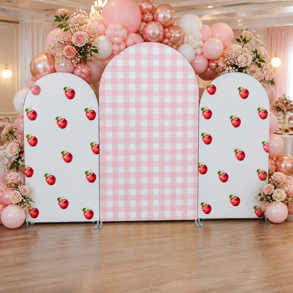 Decorated pink apple checkered arch backdrop with balloon garland