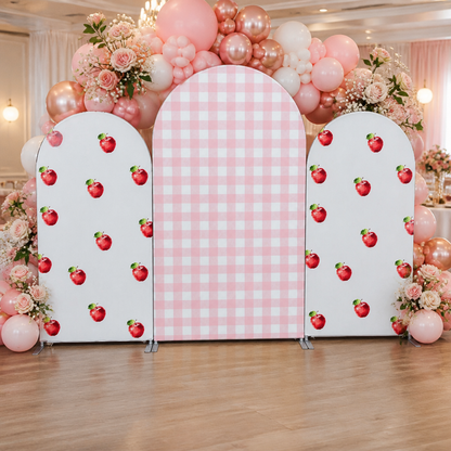 Decorated pink apple checkered arch backdrop with balloon garland