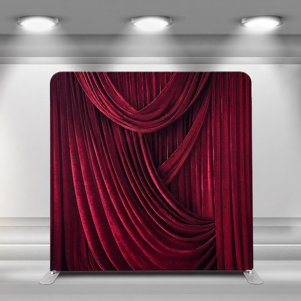 Velvet red draped curtain backdrop in studio setting under spotlight