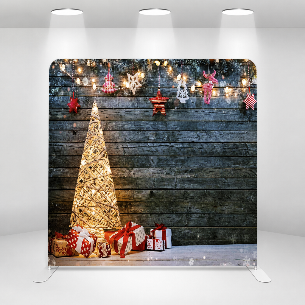 Front view under spotlights showing Christmas tree backdrop with balloon arch
