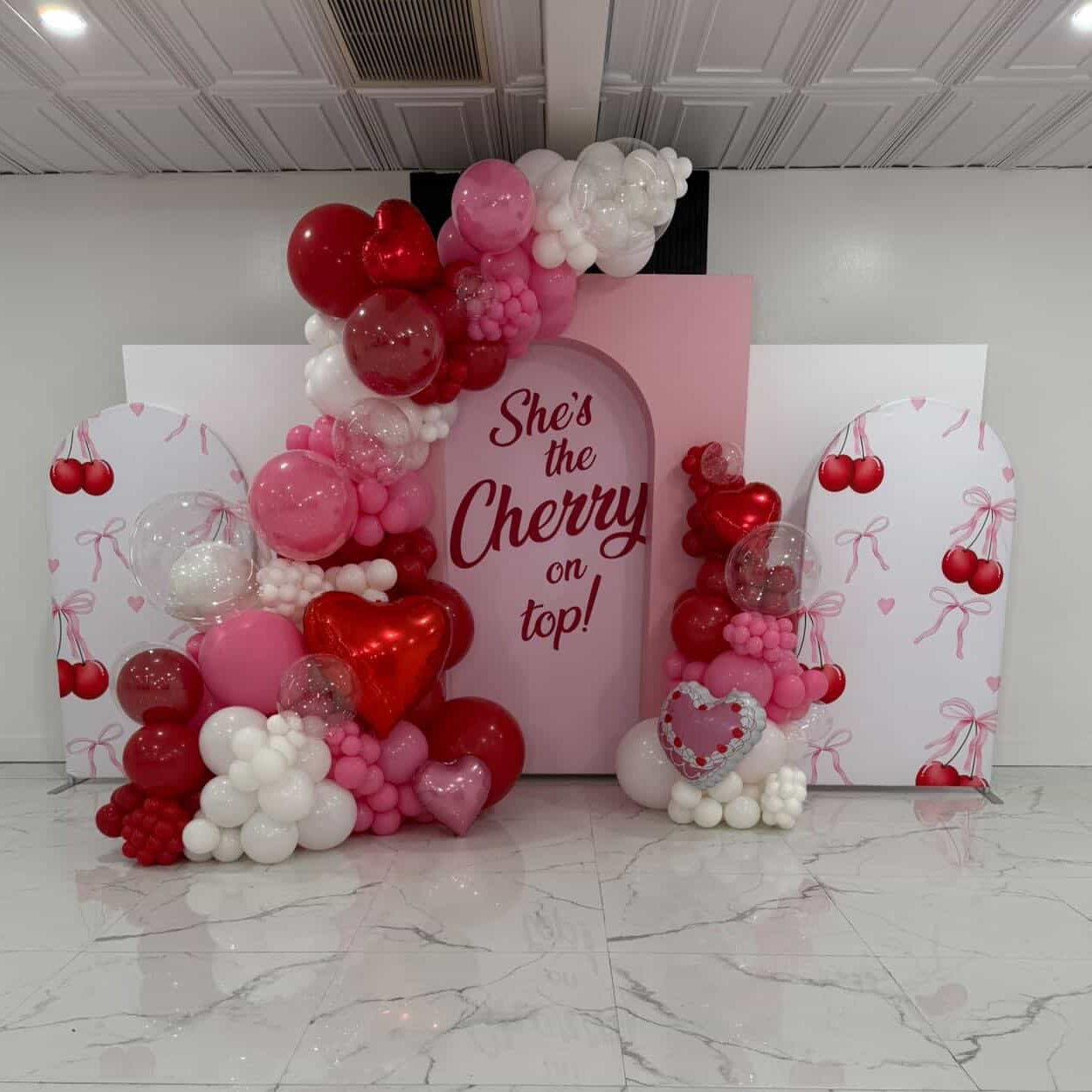 he is The Cherry On Top Party Arch Backdrop Wall