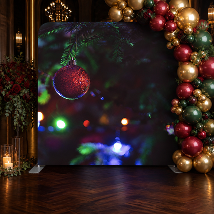 Holiday party backdrop with red ornament and festive balloon arrangement