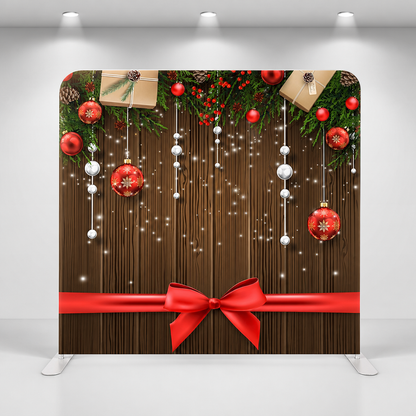 Holiday party backdrop with Christmas gifts, ornaments, and red ribbon