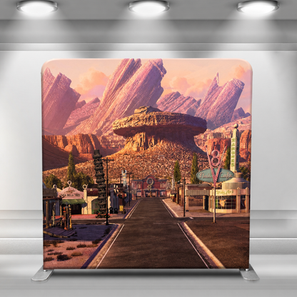 Route 66 desert town scene backdrop with red rock formations and sunset